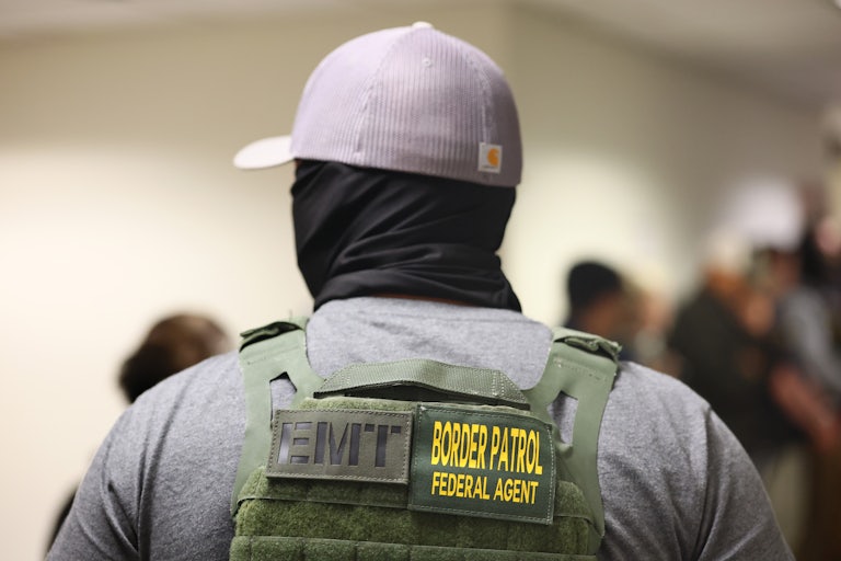A federal immigration officer stands in the hallway outside a courtroom in New York City