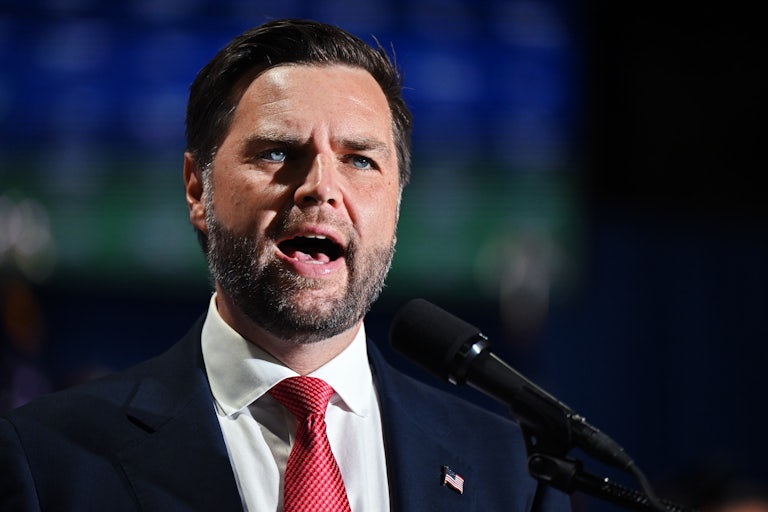 J.D. Vance speaks before a mic, brows furrowed