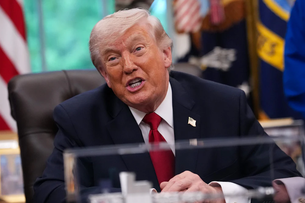Donald Trump speaks vehemently while sitting