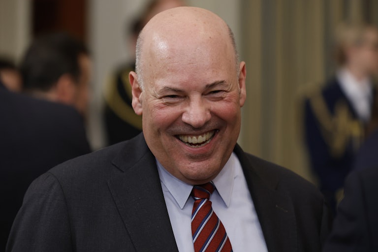U.S. Postmaster General Louis DeJoy laughs.
