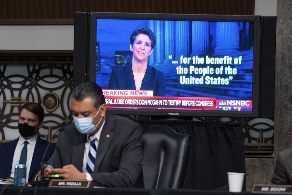 A clip from the Rachel Maddow Show plays during a Senate Judiciary Committee hearing