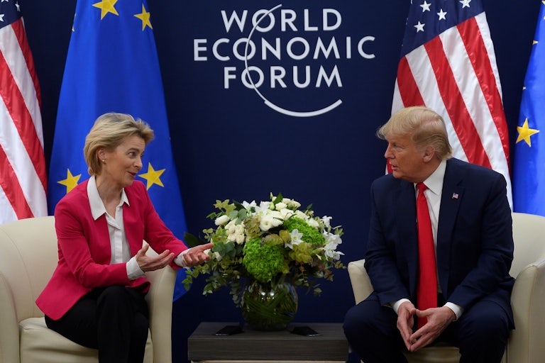 Ursula von der Leyen speaks to Donald Trump while sitting next to him at the World Economic Forum