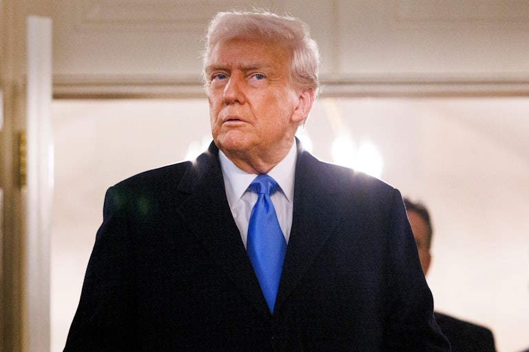 Donald Trump enters a room at the White House for a press conference