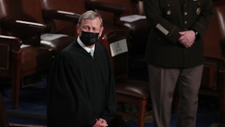 A close up of a masked John Roberts.