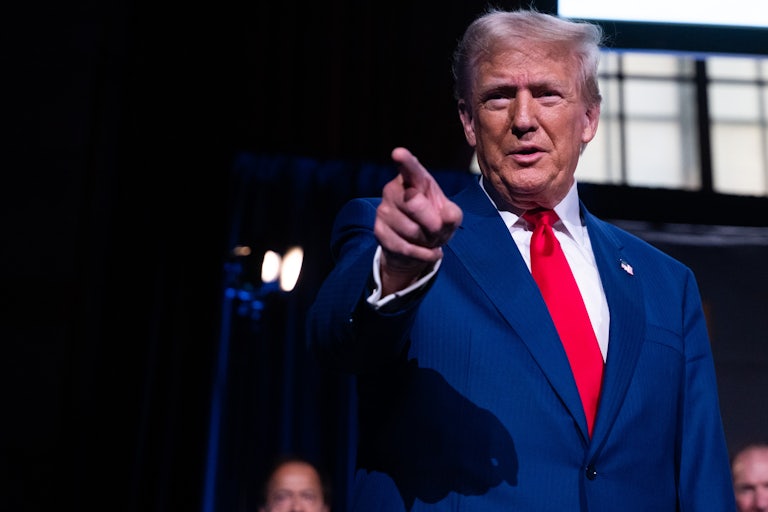 Donald Trump smiles and points
