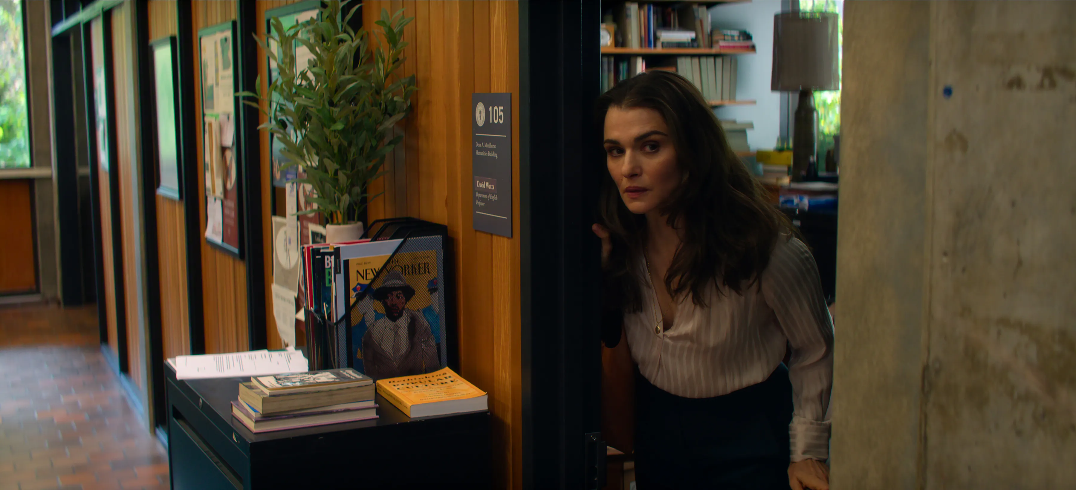 Rachel Weisz poking her head out of the door of an office in “Vladimir”