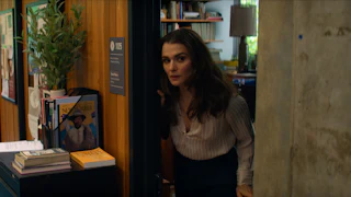 Rachel Weisz poking her head out of the door of an office in “Vladimir”