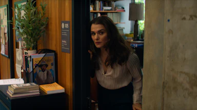 Rachel Weisz poking her head out of the door of an office in “Vladimir”