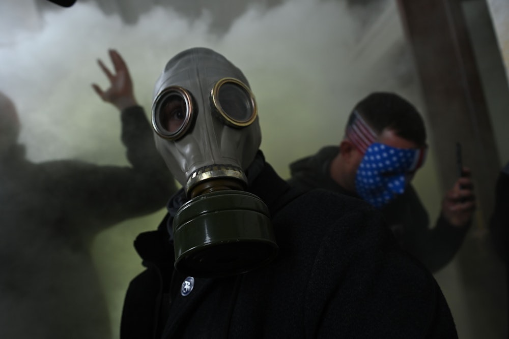 A Trump supporter wears a gas mask after storming the U.S. Capitol.