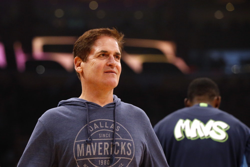 Dallas Mavericks owner Mark Cuban stares at the basketball court before an NBA match.
