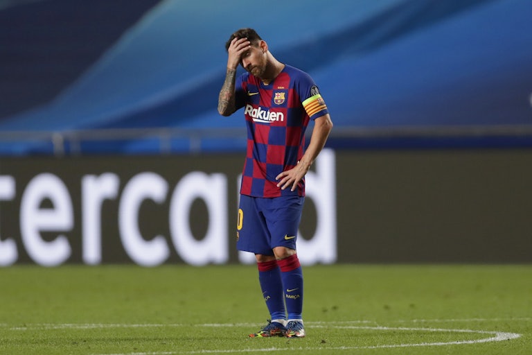 A dejected Lionel Messi holds his head in his hands after a match.