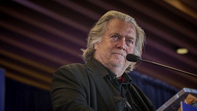 Steve Bannon stands at a podium