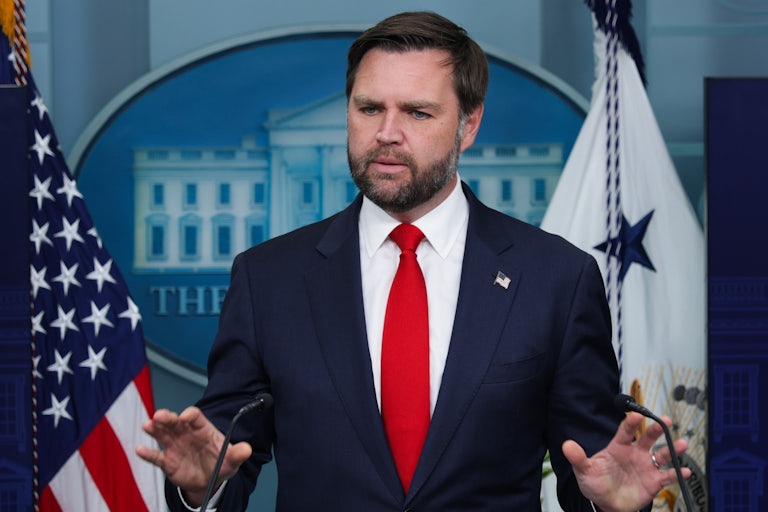 JD Vance gestures while speaking to reporters in the White House press briefing room