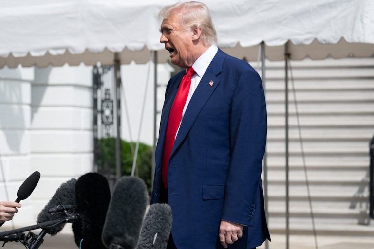 Donald Trump speaks to reporters outside the White House.