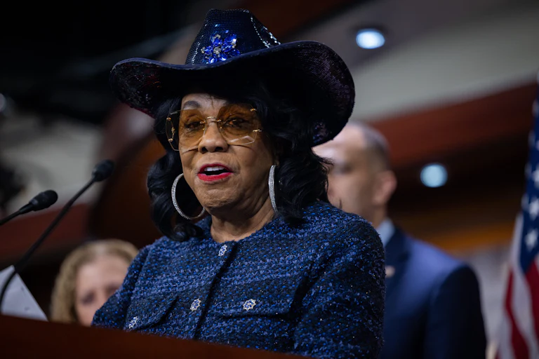 Representative Frederica Wilson speaks at a podium during a press conference