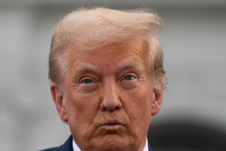 Donald Trump purses his lips during a press conference