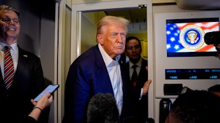 Donald Trump takes a question from a reporter aboard Air Force One.