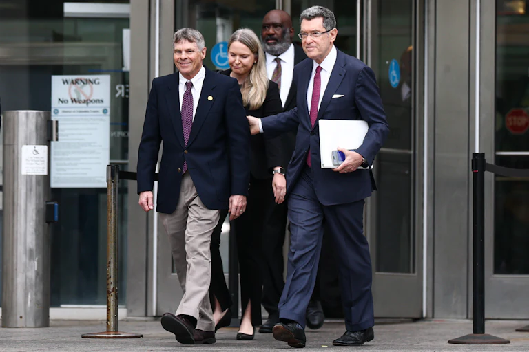 Former Olympian David Hearn walks with his attorney Norman Eisen outside Moultrie Courthouse on July 9 in Washington, D.C.