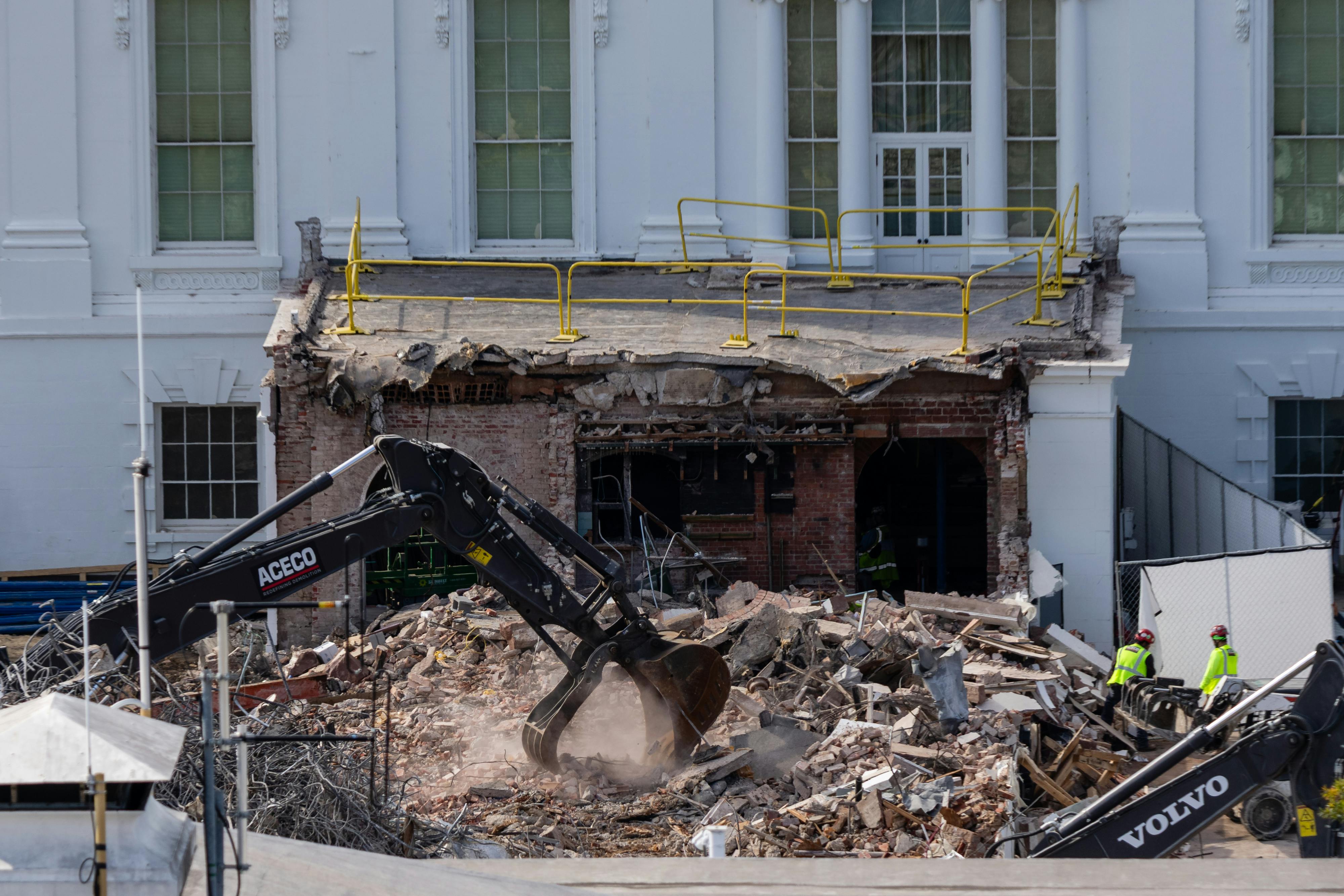 An excavator clears rubble at the White House East Wing during demolition for Donald Trump's ballroom