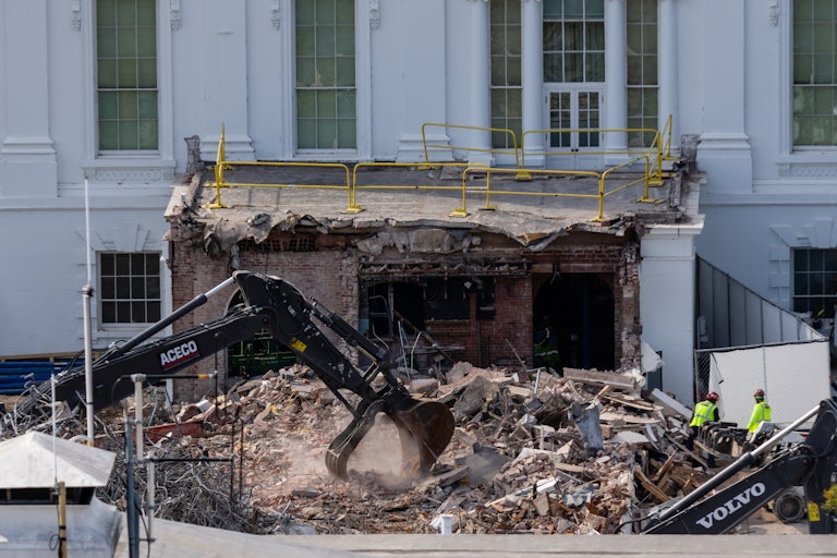 An excavator clears rubble at the White House East Wing during demolition for Donald Trump's ballroom