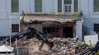 An excavator clears rubble at the White House East Wing during demolition for Donald Trump's ballroom
