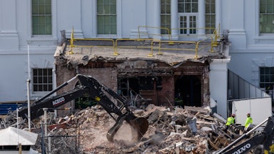 An excavator clears rubble at the White House East Wing during demolition for Donald Trump's ballroom