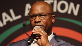 Jamaal Bowman holds a microphone.