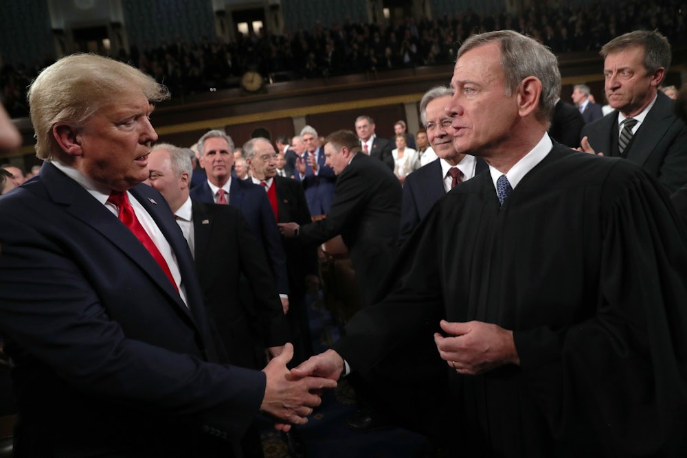 Donald Trump shakes hands with Supreme Court Chief Justice John Roberts before the State of the Union address in 2020.