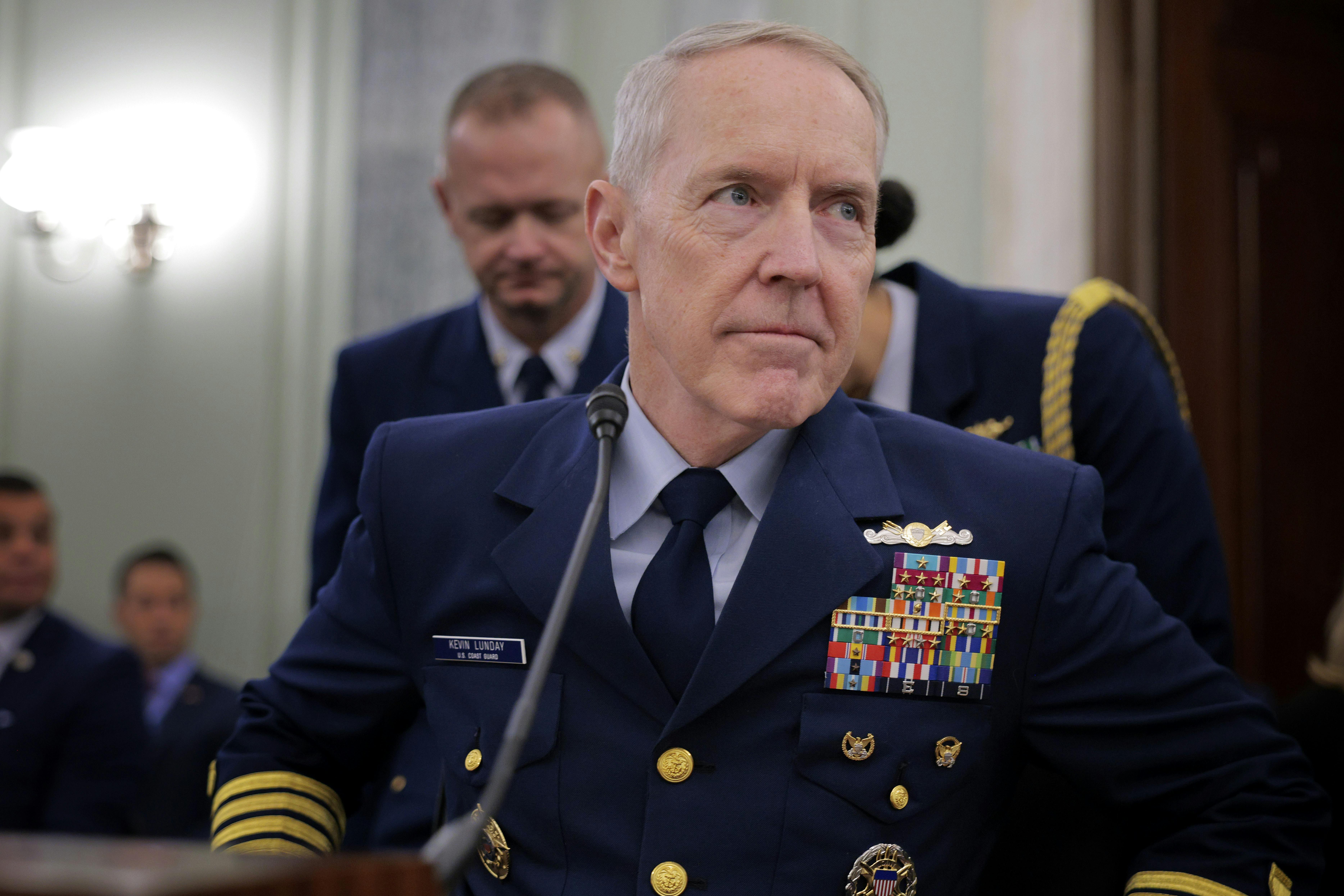Admiral Kevin Lunday sits at a table during a hearing