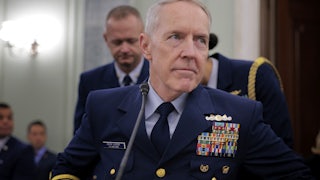 Admiral Kevin Lunday sits at a table during a hearing