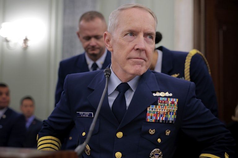Admiral Kevin Lunday sits at a table during a hearing