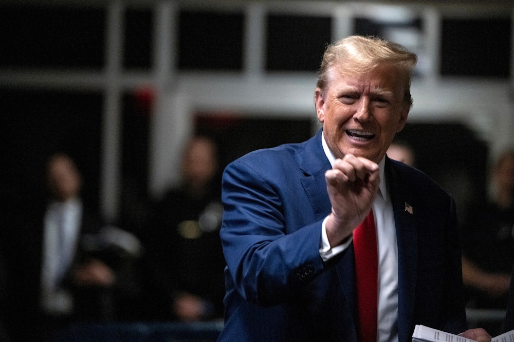 Donald Trump gestures with one hand.
