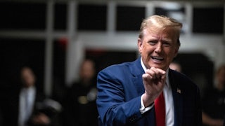 Donald Trump gestures with one hand.