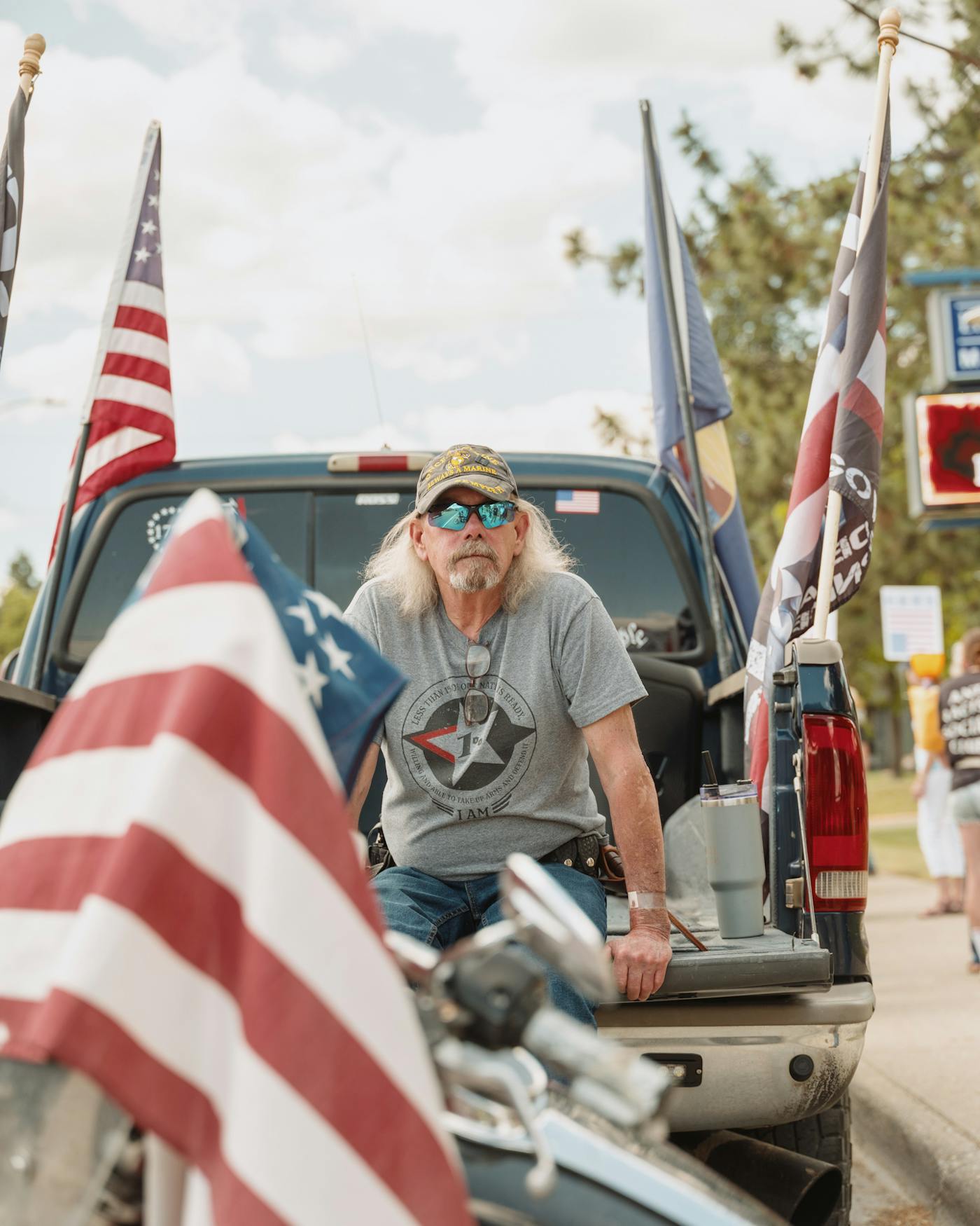 Stephen Erikson, who is second in command of the "Appeal to Heaven" militia group takes a rest in the back of a truck during the No Kings rally in Libby Montana on June 14