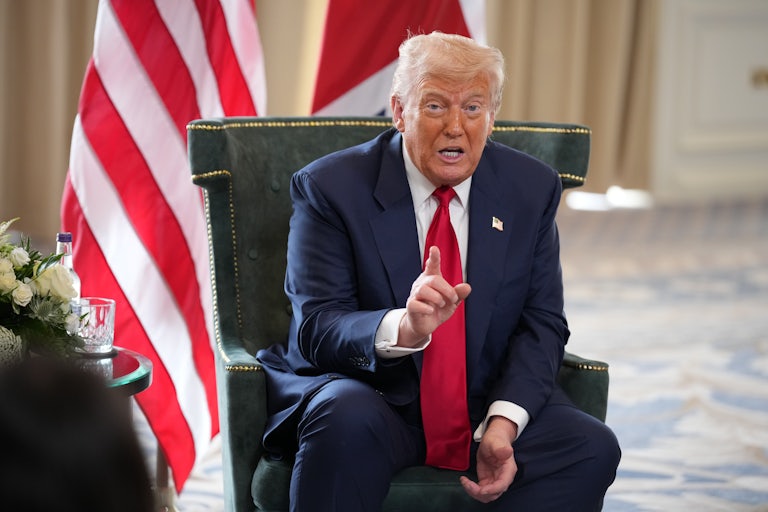 Donald Trump raises a finger while speaking during a press conference