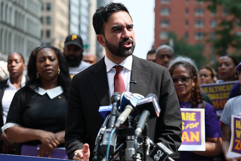 New York City Democratic mayoral nominee holds a press confoerence as others on his team stand behind him.