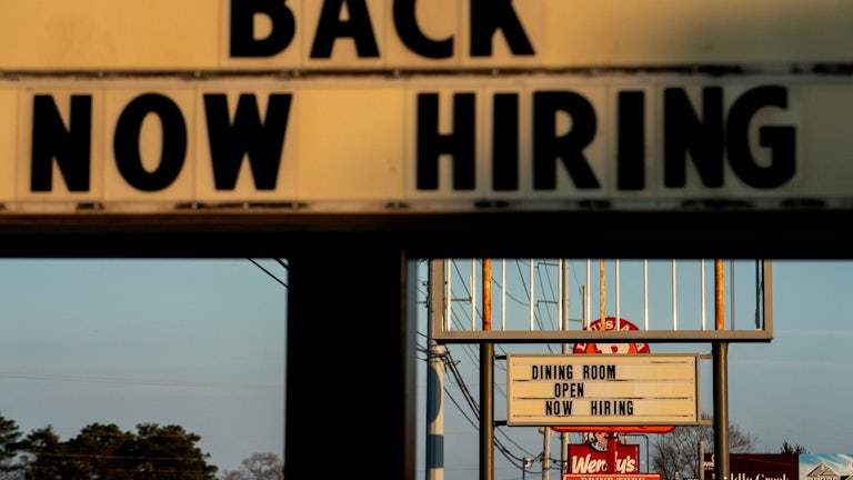 Restaurant signs that say “now hiring” in Rehoboth Beach, Delaware