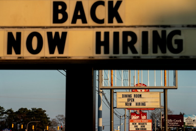 Restaurant signs that say “now hiring” in Rehoboth Beach, Delaware