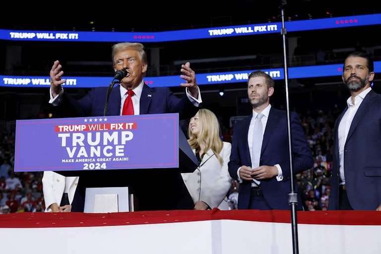 Donald Trump speaks at a Pennsylvania campaign event with his daughter Tiffany and his sons Eric and Donald Jr. standing behind him.