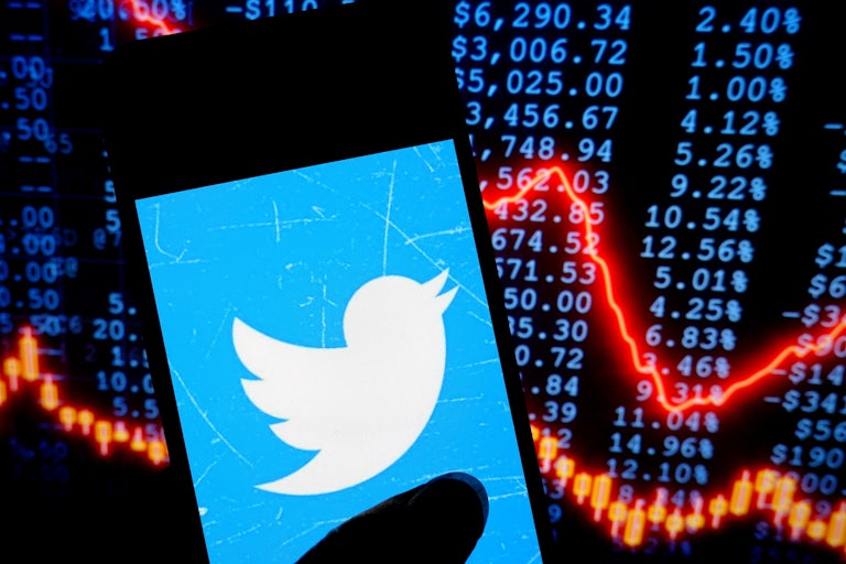 In this photo illustration, a Twitter logo is seen displayed on a smartphone .