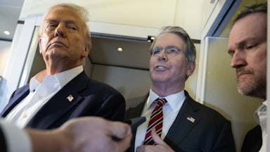 Treasury Secretary Scott Bessent speaks to reporters on Air Force One while standing between Donald Trump and Trade Representative Jamieson Greer