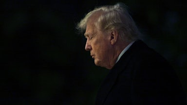 Donald Trump walks on the South Lawn after landing at the White House.
