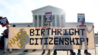 People outside the Supreme Court hold up signs reading "Trump must go now" and "Hands off Birthright Citizenship."