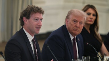 Meta CEO Mark Zuckerberg speaks as U.S. President Donald Trump and first lady Melania Trump listen, all three sitting side by side.
