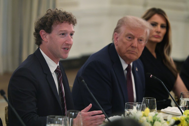Meta CEO Mark Zuckerberg speaks as U.S. President Donald Trump and first lady Melania Trump listen, all three sitting side by side.