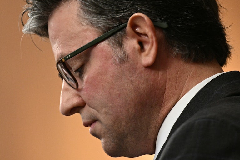 House Speaker Mike Johnson is seen in profile as he looks down during a press conference