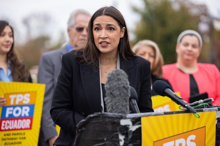 Alexandria Ocasio-Cortez speaks at a podium during a press conference
