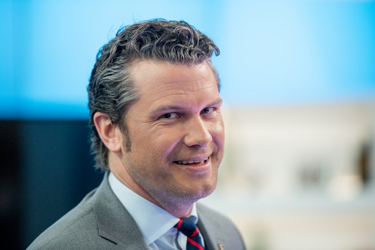 Pete Hegseth smiles.