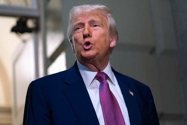 Donald Trump speaks to reporters outside the Capitol