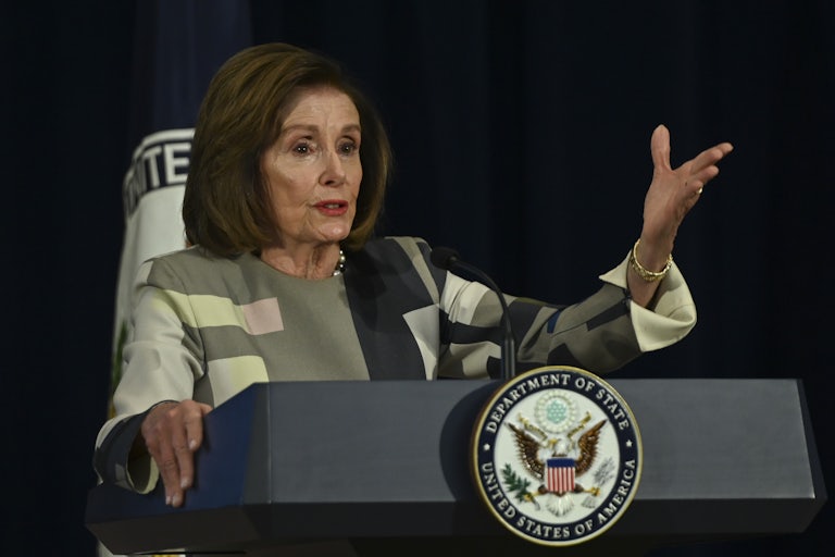 Nancy Pelosi delivering a speech at a State Department podium